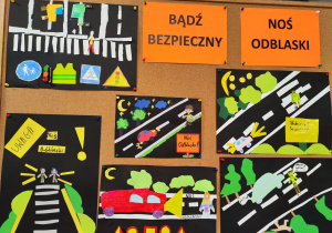 Na tablicy korkowej wiszą prace na temat noszenia odblasków. Widać również napis "Bądź bezpieczny, noś odblaski"